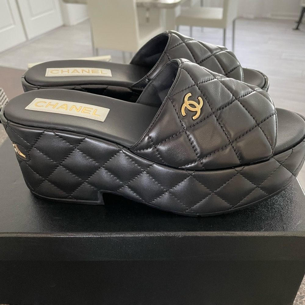 NIB Chanel black quilted mules with gold Chanel lettering. Purchased this season